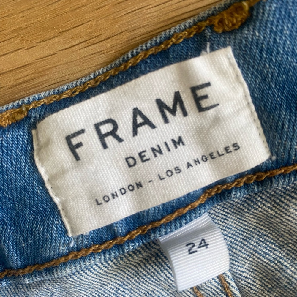 Frame denim jeans. Wide legged. High to mid waist with frayed edge bottom.